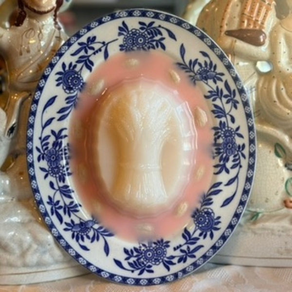 Pink Harvest Blancmange on a Blue Oval Plate