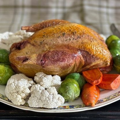 Roast pheasant with vegetables on a lovely oval plate