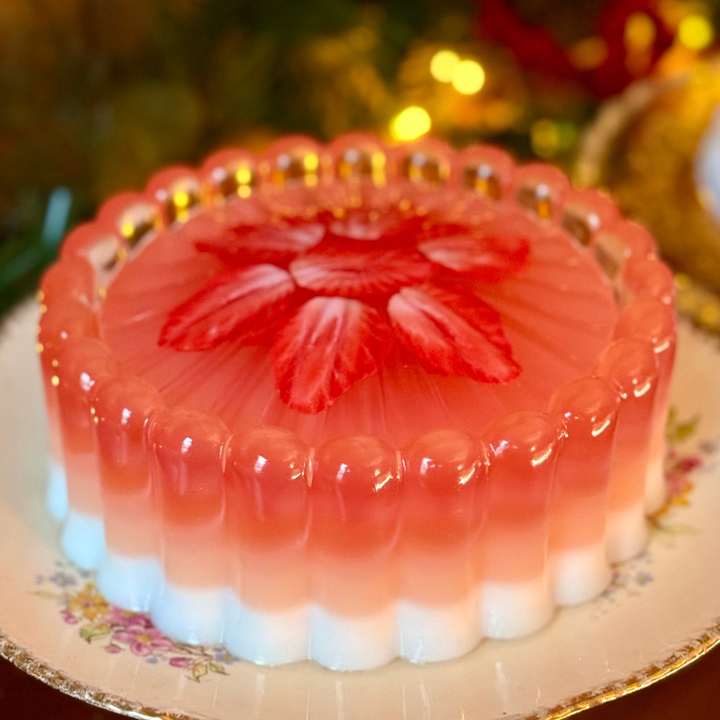 Pink jelly cake with a floral design on a decorative plate