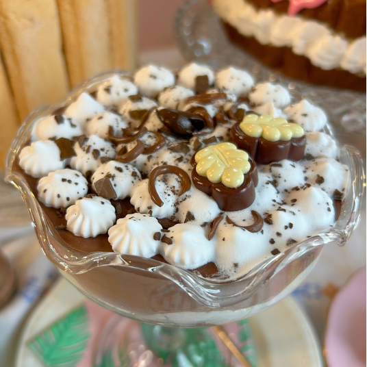 Dessert with chocolate and white elements on a glass dish