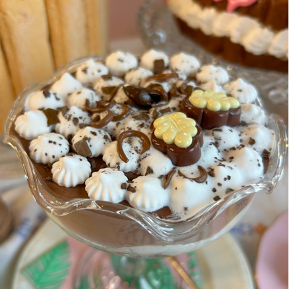 Dessert with chocolate and white elements on a glass dish
