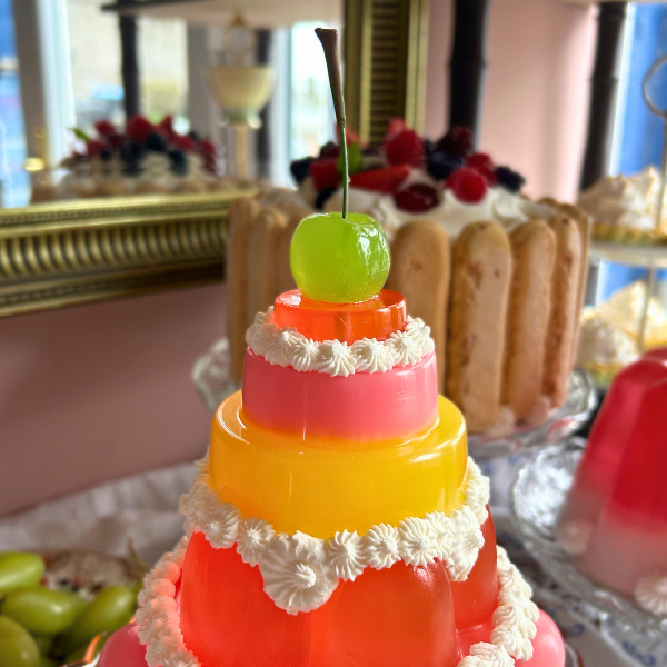 Red, Yellow and Pink Tiered Jelly with Green Cherry