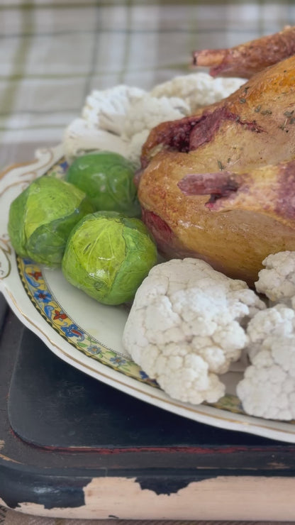 Roast pheasant with vegetables on a lovely oval plate